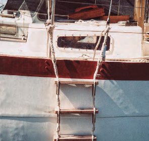 Richard transformed a plank retrieved from the harbor and a couple of lengths of three-strand rope into a practical and effective ladder.