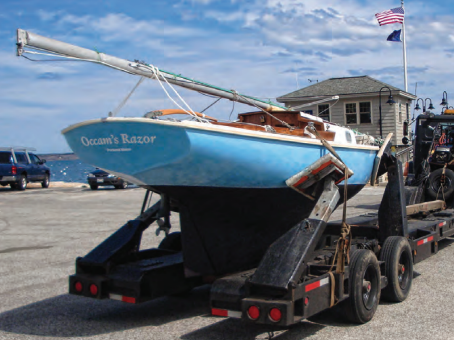 On a breezy spring day in 2009, Occam’s Razor hitched a ride to the launch ramp. Her gleaming brightwork and polished gelcoat highlight the work Kegan put into her restoration.