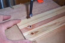 By fitting the runner into the drawer side and drilling the two simultaneously, he ensured the stop was perfectly aligned.