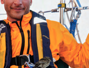 A man sitting with a bird