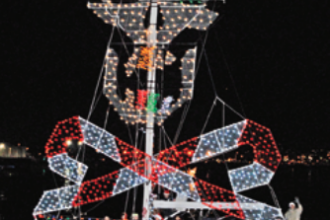 Picture of a boat with christmas jolly roger lights