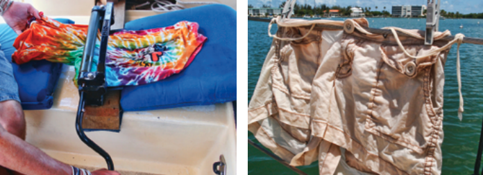 Connie uses an old-fashioned wringer, at left, to wring out the soapy water before rinsing, then again to remove the rinse water. To ensure the clothes can resist the trade winds, Connie uses their buttons and cords to back up the clothespins holding them on the lifelines, at right.
