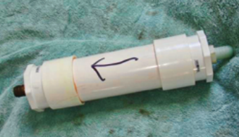 Assembling the filter is easy. The arrow points to the top bushing, which can be removed for recharging the filter.