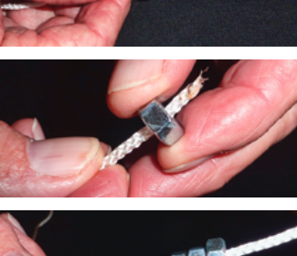 Carl’s weighted halyard messenger begins with a figure-eight knot tied several inches from the end of the line, at top. He then threads steel nuts onto the messenger line to create a weight flexible enough to pass over a sheave, at middle and above. Another knot tied at the end of the messenger keeps the nuts from falling off.