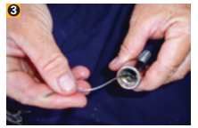 Clean the threads inside the fitting. A strand of wire works well for this.