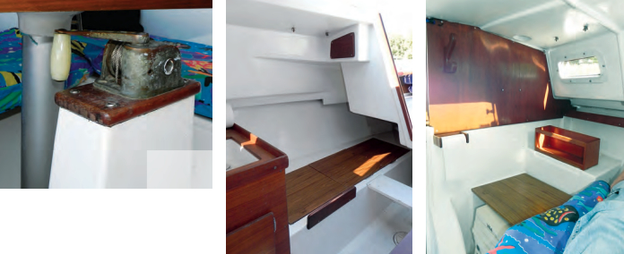 The swing keel’s winch is easier to operate with the table removed, above, but Steve raises and lowers the keel with the table in place. A quarter berth is to starboard, near right, and the bulkhead gives the V-berth privacy, far right.