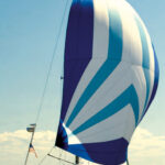 Mystic, a C&C 30, shows off her pert sheer while sailing under the spinnaker her owners, Good Old Boat’s Karen Larson and Jerry Powlas, built from a Sailrite kit. The kayak they use for ship-to-shore excursions and exploring takes up some deck space but doesn’t hamper the sailing activities.
