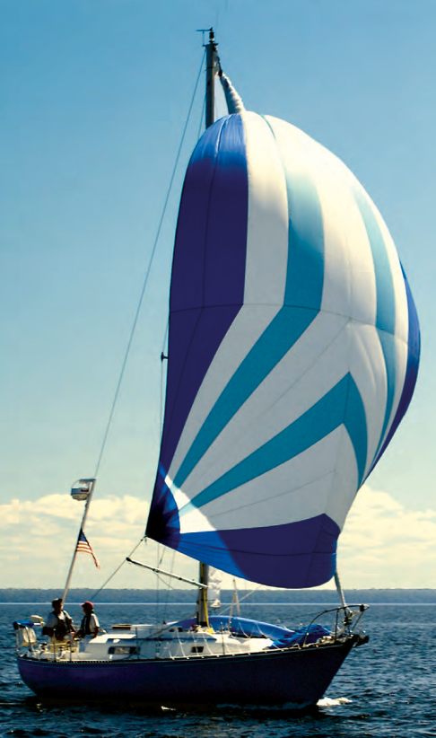 Mystic, a C&C 30, shows off her pert sheer while sailing under the spinnaker her owners, Good Old Boat’s Karen Larson and Jerry Powlas, built from a Sailrite kit. The kayak they use for ship-to-shore excursions and exploring takes up some deck space but doesn’t hamper the sailing activities.