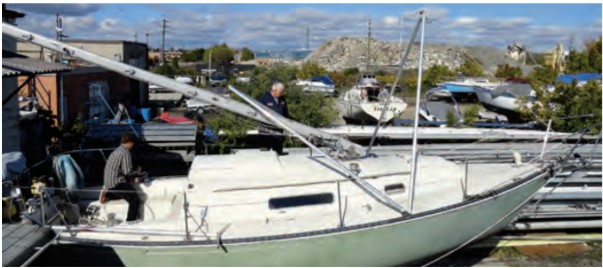 Two A-frames share common pivot points at the deck and are connected by a wire between their apexes. The forward one provides the raising lever and the after one lateral support for the mast.