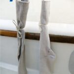 Old socks protect Marilyn’s brightwork and gelcoat from dings from the turnbuckles and the turnbuckles from dirt.