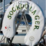 Safety regulations require boats to carry throwable flotation devices but are silent on their color or decoration. Karen used the loophole to artistic advantage.