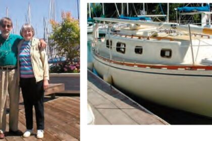 photo of an elderly couple and a sailboat at dock.