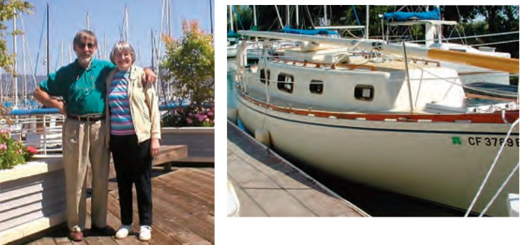 photo of an elderly couple and a sailboat at dock.