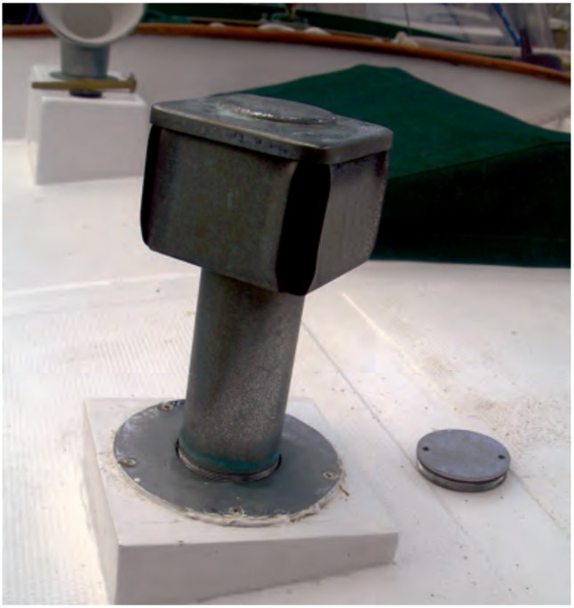 The Charlie Noble screws into a deck plate so it can be removed and the opening closed in summer.