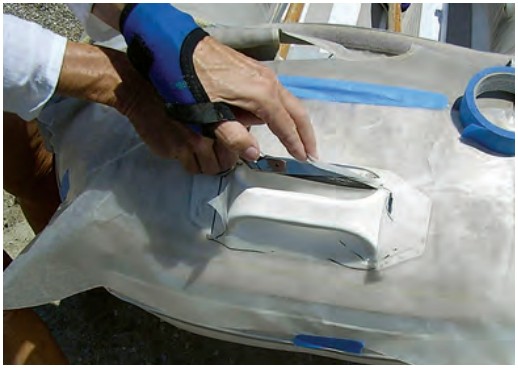 Once the pattern has been shaped to the dinghy, the rough cutouts must be smoothed and the extra pieces cut away.