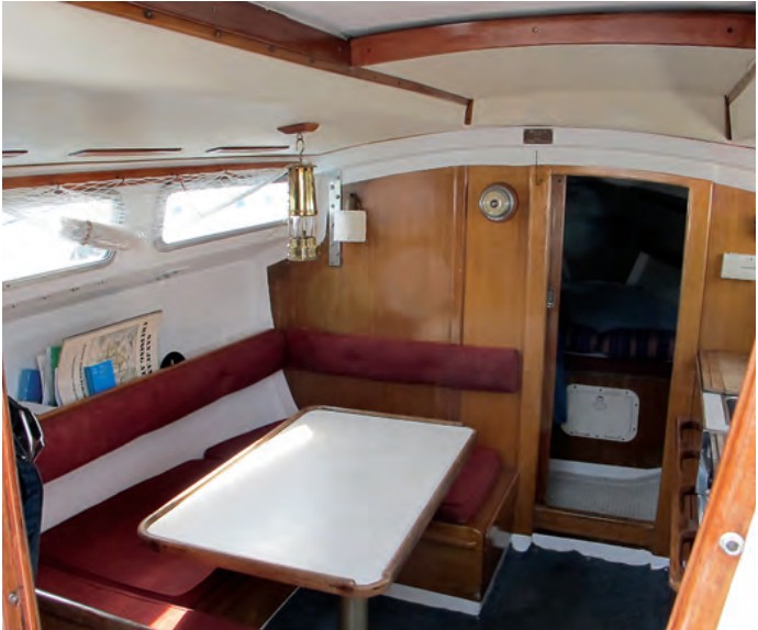The table drops to make a double berth. Removing the wooden strips in the overhead provides access to the nuts and bolts that secure deck hardware.