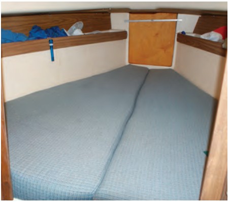The narrowing of the V-berth forward constricts foot space. No access to the forepeak is provided from the deck.