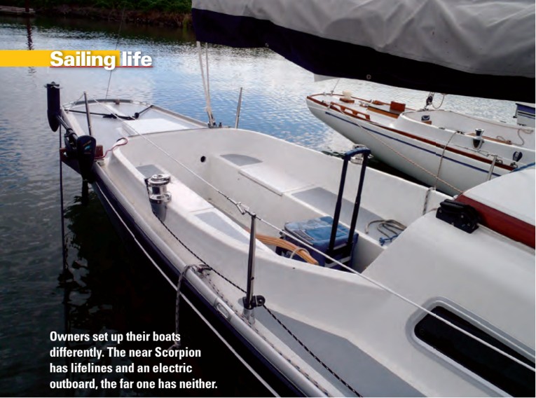 Owners set up their boats differently. The near Scorpion has lifelines and an electric outboard, the far one has neither.