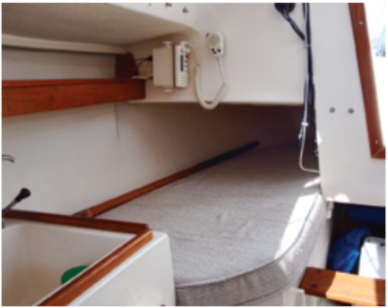 Aft of the galley is a quarter berth. A portable toilet is kept behind the companionway step.
