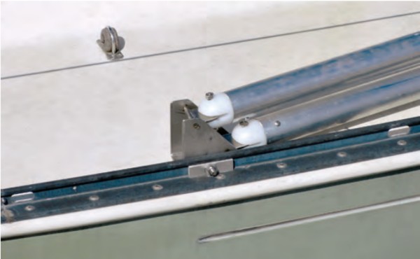The deck pivot is designed to allow the A-frames to stow one on top of the other when folded down. The toggle connections allow freedom of movement. The bracket is bolted to the toerail so it can be easily removed when not needed.