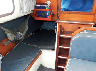 A settee aft of the galley is a good place to prepare for going on watch and also makes access to the quarter berth somewhat easier.