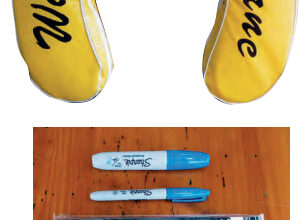 When adhesive-backed vinyl letters refused to stick to the buoy’s vinyl cover, Ferman went to permanent markers and stencils, below.