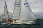 Sailing at speed, an Allied XL 242, a late CCA design, gains sailing length when its long stern overhang becomes immersed.