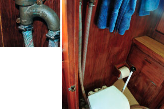 The vented loop prevents back-flooding via the toilet. To pump water into the head, Glyn places a finger over the vent hole.