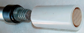 The coupler and dowel fit neatly inside the PVC pipe.
