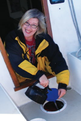 First mate, wife, and mother, Melissa pours the engine a “cuppa” in her new role as mechanic.