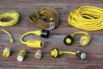 The contents of a typical shorepower bag, from left to right. Top row: cable-TV cord, telephone cord, 30A 125VAC power cord. Middle row: 30A 125VAC to 15A 125VAC adapter, 50A 125VAC to 30A 125VAC adapter, 50A 250/125VAC to 30A 125VAC adapter. Bottom row: polarity checker, 15A 125VAC to 30A 125VAC adapter, 30A 125VAC to 15A 125VAC adapter, 20A 125VAC to 30A 125VAC adapter. It’s a good idea to label the adapter with not only the type of socket it fits, but also with the name of your boat, so that on a marina dock there’s no question about who owns the adapter.