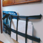Charts accumulate in great numbers on a cruising boat and storing them flat often presents a challenge. Connie turned the problem on its side and attached a “chart basket” to a bulkhead.
