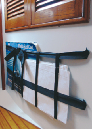 Charts accumulate in great numbers on a cruising boat and storing them flat often presents a challenge. Connie turned the problem on its side and attached a “chart basket” to a bulkhead.