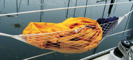 Under way, a string hammock provides a handy repository for extra layers of clothing.