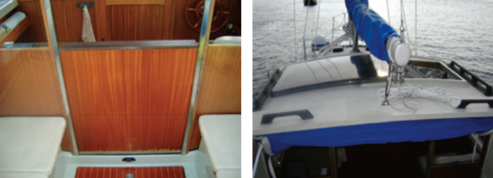 Instead of dropboards, the cockpit is sealed off from the pilothouse by this innovative door that pulls up from a pocket in the bulkhead where it is stowed out of the way, at left. Larry installed extra custom handholds to give him more security when going forward, at right. Note the sliding hatch over the helm seat and the cockpit awning folded away just behind the pilothouse.