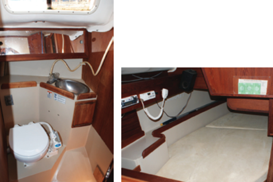 The head features a marine toilet with large holding tank, a small sink, and a handheld shower. On the standard boat, the only opening portlight is here, at left. The starboard-side quarter berth is comfortably wide, below.