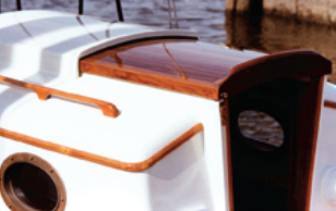 After stepping through the teak companionway hatch, Paul used its parts as patterns for constructing a new one, then built the sea hood to keep the sea on the outside.