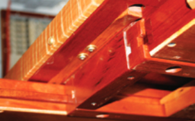 In this view from below the table, the left-hand drawer is open and the right-hand drawer is held closed by the narrow oak strip set into the underside of the table. Between the drawers is the stop that prevents the tabletop from sliding off the base.