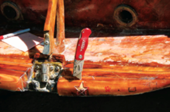 After drawing the stars on the transom, Marlin used a razor knife to cut around their outlines and hollow them out. He filled the stars with homemade wood-epoxy filler, then sanded and epoxied the area and applied several coats of glossy clear polyurethane with UV filters.