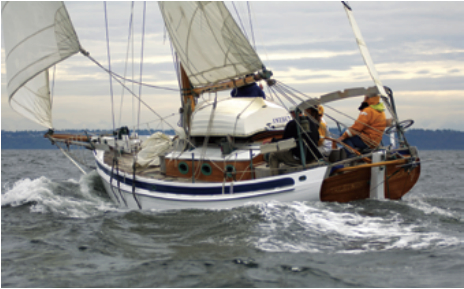 Whenever Lin and Larry see folks taking pictures of Taleisin, they try to sail up close and ask if the photographer could please send copies of the photos. They pass over one of their cards with a note promising to give credit for the use of the photo plus any payment they receive. When they saw Darren Emmens shooting pictures near Seattle, they didn’t know he was a professional, but when they saw his work, at right, they were glad they’d approached him and made the offer.