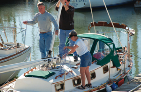 A new journey ahead: Ron, Terrel, and son-in-law Michael Paxon, center, get set to raise Envy’s mast.