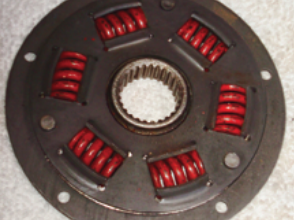 The damper plate is constructed of two plates and springs. The transmission shaft fits into a toothed hole in the center.