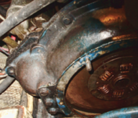 With the transmission slid back, the damper plate is visible inside the bell housing.