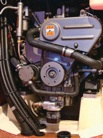 The new oil filter is located at the front of the engine below the crank-shaft pulley. The oil sump pump is also visible at the top left of the photo.