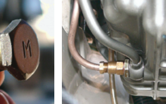 To add a suction line for an oil-change pump, Benjy had the banjo bolt that secures the oil dipstick tube drilled through the “M,” far left. He then attached the pump tube (copper color) to the dipstick assembly, near left.