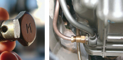 To add a suction line for an oil-change pump, Benjy had the banjo bolt that secures the oil dipstick tube drilled through the “M,” far left. He then attached the pump tube (copper color) to the dipstick assembly, near left.