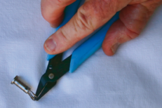 Specially made pliers are tougher than fingernails and better for opening split rings — and they can be had for less than the price of a manicure.