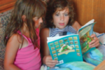 Two girls reading a book