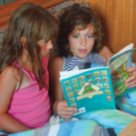 Two girls reading a book
