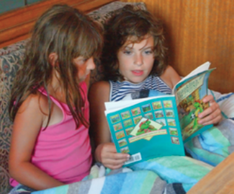 Two girls reading a book